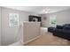 Relaxing upstairs loft area with comfortable seating, built-in shelving, and lots of natural light at 1210 Tabitha Ct, Monroe, NC 28110