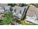 Aerial view showcasing a well-maintained home with mature landscaping, a manicured lawn, and a charming white picket fence at 126 Blandina Ct, Fort Mill, SC 29708