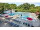 Large community pool with numerous lounge chairs and umbrellas surrounded by mature trees at 126 Blandina Ct, Fort Mill, SC 29708