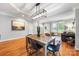 Bright dining area featuring a wooden table, modern lighting fixture, and hardwood floors at 126 Blandina Ct, Fort Mill, SC 29708