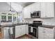 This well-designed kitchen features granite counters, stainless appliances, and hardwood flooring at 126 Blandina Ct, Fort Mill, SC 29708