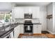 Well-lit kitchen features granite counters, stainless appliances, white cabinetry, and hardwood flooring at 126 Blandina Ct, Fort Mill, SC 29708