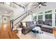 Spacious living room featuring a staircase, large sectional, and hardwood floors at 126 Blandina Ct, Fort Mill, SC 29708