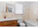 Bathroom with a tub/shower combination, sink with vanity, and a window above toilet at 128 Howie St, Mount Holly, NC 28120