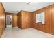 Cozy bedroom with wood paneled walls and a window offering natural light at 128 Howie St, Mount Holly, NC 28120