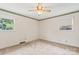 Bedroom with two windows, neutral walls, and neutral carpet with ceiling fan at 128 Howie St, Mount Holly, NC 28120