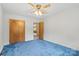 Bedroom with a window for natural light, ceiling fan, blue carpet and closet at 128 Howie St, Mount Holly, NC 28120