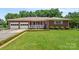 Charming brick home featuring an attached two-car garage and a welcoming front porch at 128 Howie St, Mount Holly, NC 28120