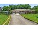 Charming brick home with a two-car garage, carport, and manicured lawn at 128 Howie St, Mount Holly, NC 28120
