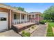 Charming front porch with brick accents and a well-maintained yard at 128 Howie St, Mount Holly, NC 28120
