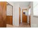 Hallway shows paneled walls and access to rooms, including a closet and exterior door at 128 Howie St, Mount Holly, NC 28120