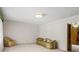 A cozy living room with carpet flooring, a couch, and an armchair at 128 Howie St, Mount Holly, NC 28120