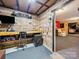 Basement area featuring custom wood paneling, a workbench, ample storage, and an adjacent recreation room at 130 Nims Spring Dr, Fort Mill, SC 29715