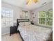 Bright bedroom featuring a bed with decorative pillows and lots of natural light from three windows at 130 Nims Spring Dr, Fort Mill, SC 29715