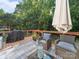 Outdoor deck area with grill, patio furniture, and wooded backdrop at 130 Nims Spring Dr, Fort Mill, SC 29715