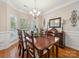 Formal dining room with large bay windows and a wooden table that seats eight at 130 Nims Spring Dr, Fort Mill, SC 29715