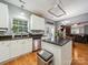 Kitchen features white cabinets, stainless steel appliances, tile backsplash, granite counters, and an island at 130 Nims Spring Dr, Fort Mill, SC 29715