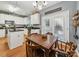 Eat-in kitchen boasts white cabinets, stainless steel appliances, and a breakfast area perfect for Gathering dining at 130 Nims Spring Dr, Fort Mill, SC 29715