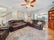 Cozy living room features leather sofas, a decorative rug, and access to the stairs and kitchen at 130 Nims Spring Dr, Fort Mill, SC 29715