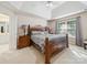 Primary bedroom showcasing a beautiful wooden bed frame, vaulted ceiling, and a large window at 130 Nims Spring Dr, Fort Mill, SC 29715