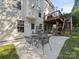 Backyard patio with an outdoor table and stairs leading to the deck above at 130 Nims Spring Dr, Fort Mill, SC 29715