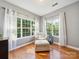 Sitting area with a comfy armchair, ottoman, and large windows for plenty of natural light at 130 Nims Spring Dr, Fort Mill, SC 29715