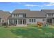 A spacious backyard with a playhouse, patio and a sunroom on the back of the house at 1335 Bryson Gap Dr, Fort Mill, SC 29715
