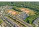 Aerial view features multiple baseball fields and a parking lot surrounded by neighborhood homes at 1335 Bryson Gap Dr, Fort Mill, SC 29715