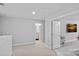 Neutral bedroom with TV, carpet, and ensuite bathroom at 1335 Bryson Gap Dr, Fort Mill, SC 29715