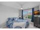 Bedroom features a large window with drapes, ceiling fan, and blue patterned bedding at 1335 Bryson Gap Dr, Fort Mill, SC 29715