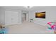 Large bonus room with carpeted floors, closet, and mounted TV at 1335 Bryson Gap Dr, Fort Mill, SC 29715