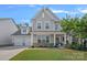 Charming two-story home featuring a two-car garage and landscaped front yard at 1335 Bryson Gap Dr, Fort Mill, SC 29715