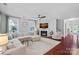 Bright living room with fireplace, large sectional, and dark hardwood floors at 1335 Bryson Gap Dr, Fort Mill, SC 29715