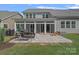A patio area with outdoor seating, a grill, and a view of the home's sunroom at 1335 Bryson Gap Dr, Fort Mill, SC 29715
