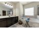 Modern bathroom features a soaking tub, double vanity, and a tiled shower, creating a spa-like retreat at 13519 Crystal Springs Dr # 148, Huntersville, NC 28078