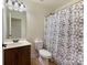 Bathroom featuring vanity, toilet, and shower/tub with decorative curtain at 13519 Crystal Springs Dr # 148, Huntersville, NC 28078