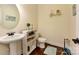 Powder room featuring a pedestal sink, decorative mirror, and neutral decor at 13519 Crystal Springs Dr # 148, Huntersville, NC 28078