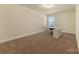 Bonus room features a desk and chair with neutral walls and carpet at 13519 Crystal Springs Dr # 148, Huntersville, NC 28078