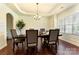 Elegant dining room with hardwood floors, a decorative chandelier, and wainscoting at 13519 Crystal Springs Dr # 148, Huntersville, NC 28078