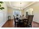 Elegant dining room with hardwood floors, a decorative chandelier, and wainscoting at 13519 Crystal Springs Dr # 148, Huntersville, NC 28078