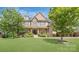 Charming brick home featuring a well-manicured lawn, landscaped garden and a covered front porch at 13519 Crystal Springs Dr # 148, Huntersville, NC 28078