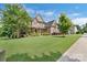 Charming brick home featuring a well-manicured lawn, landscaped garden and a covered front porch at 13519 Crystal Springs Dr # 148, Huntersville, NC 28078