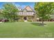 Charming brick home featuring a well-manicured lawn, landscaped garden and a covered front porch at 13519 Crystal Springs Dr # 148, Huntersville, NC 28078
