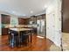 Stylish kitchen with dark cabinets, stainless appliances, and an island with seating at 13519 Crystal Springs Dr # 148, Huntersville, NC 28078