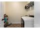 Convenient laundry room with washer and dryer, storage shelves, and practical flooring at 13519 Crystal Springs Dr # 148, Huntersville, NC 28078