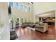 Spacious living room with hardwood floors, large windows, and a vaulted ceiling at 13519 Crystal Springs Dr # 148, Huntersville, NC 28078
