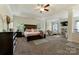 Expansive main bedroom with tray ceilings, a ceiling fan, and comfortable seating area at 13519 Crystal Springs Dr # 148, Huntersville, NC 28078