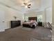 Spacious main bedroom with a tray ceiling, soft lighting, and luxurious dark wood furniture at 13519 Crystal Springs Dr # 148, Huntersville, NC 28078