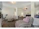 Relaxing seating area in the main bedroom, featuring plush chaise lounges and ceiling fan at 13519 Crystal Springs Dr # 148, Huntersville, NC 28078