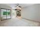 Spacious bedroom features plush carpet, natural light, ensuite bath with dark cabinets and mirrored closet at 1419 Jules Ct, Charlotte, NC 28226